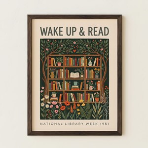 May include: A framed print featuring the words "WAKE UP & READ" above a detailed illustration of a bookshelf filled with books, plants, and a teacup. The bottom of the print reads "NATIONAL LIBRARY WEEK 1951".