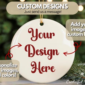 May include: A circular, cream-coloured Christmas ornament with burgundy text reading "Your Design Here". It features a gold hanging string and text that says "Custom Designs" and "Add your image or custom logo!"