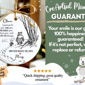 May include: A white ceramic ornament with a gold string. It features a black and white illustration of Winnie the Pooh and Piglet. Text includes a promise, baptism date, and name. The background is green with a skiing polar bear. The ornament is a keepsake.