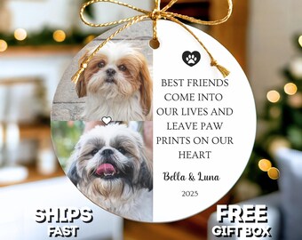 May include: A round, white ornament with two photos of a Shih Tzu dog. The ornament has a gold ribbon and the text "Best Friends Come Into Our Lives And Leave Paw Prints On Our Heart" with the names "Bella & Luna" and the year "2025".