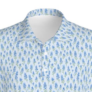May include: A light blue short-sleeved polo shirt with a white collar and a small button closure. The shirt features a repeating pattern of blue flowers on a white background.
