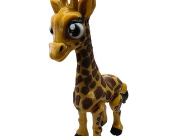 May include: A small giraffe figurine with a yellow body and brown spots. The giraffe has large, expressive eyes, two dark brown ossicones on its head, and black hooves. The figure is standing in a forward-facing position with a smooth, molded texture.
