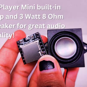 Close-up of a hand holding a DFPlayer Mini module and a 3 Watt 8 Ohm speaker side by side. The DFPlayer Mini features a built-in amplifier. Overlaid text reads 'DFPlayer Mini built-in amp and 3 Watt 8 Ohm speaker for great audio quality!