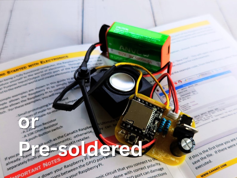 Pre-soldered DIY electronics project featuring a speaker, 9V battery, and a yellow PCB with components already mounted. The setup is placed on an open instruction manual. Overlaid text reads 'or Pre-soldered'.