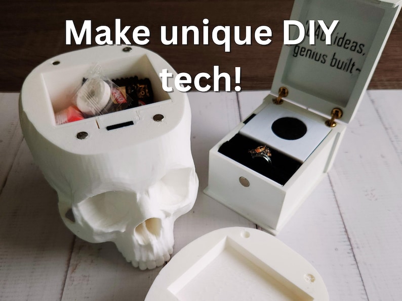 Photo of two 3D-printed DIY tech projects: a white skull-shaped container filled with candy and a small white music ring box displaying a ring. The lid of the ring box reads 'BAD ideas, genius built~'. Overlaid text says 'Make unique DIY tech!'
