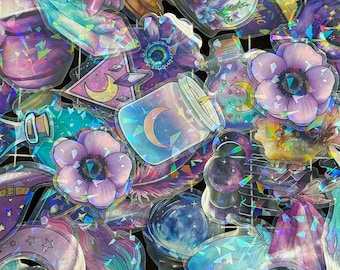May include: A collection of holographic stickers featuring celestial and mystical designs. The stickers include jars with moons, crystals, flowers, and stars in shades of purple, blue, and teal. The stickers have a shiny, iridescent finish.