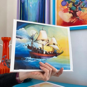 May include: A colorful print of a ship sailing on a blue sea with a yellow sky and clouds. The ship has a white sail and a red hull. There are small, blue fish swimming around the ship.