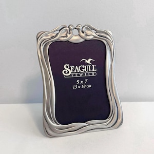 May include: A set of three ceramic mugs with a speckled, matte finish in blue, green, and white. Each mug has a simple, modern design, suitable for coffee or tea.