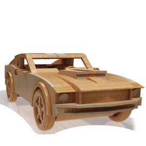 May include: A wooden toy car model in the shape of a classic muscle car. The car is made of light brown wood and has a detailed design, including a hood scoop, headlights, and wheels.