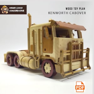 May include: A wooden toy truck model kit of a Kenworth cabover truck. The model is made of laser-cut wood and comes with instructions for assembly. The truck is painted in a natural wood colour with red wheels. The image includes the text "WOOD TOY PLAN KENWORTH CABOVER" and a PDF icon.