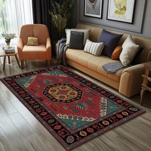 Peut inclure: Un tapis rectangulaire au design traditionnel. Le tapis présente un champ rouge avec un médaillon géométrique central jaune et noir. Des bordures turquoise et noires encadrent le motif, créant un look classique pour les salons ou les chambres.