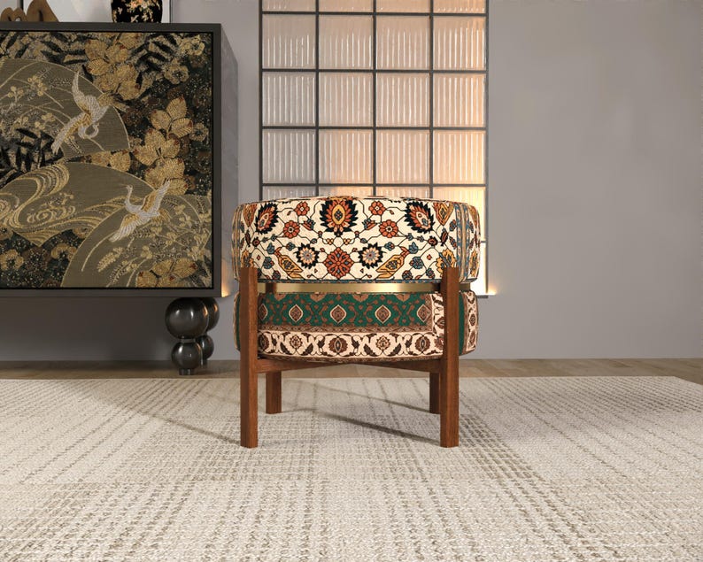 a colorful, patterned chair with a wooden frame, placed on a white rug in a minimalist living room setting.
