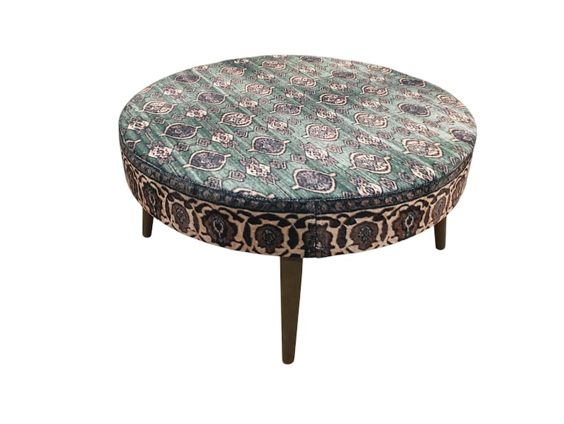 a round table with a patterned seat and legs.