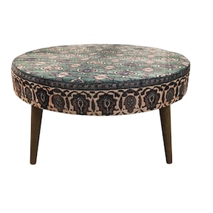 a round table with a patterned top and two wooden legs.