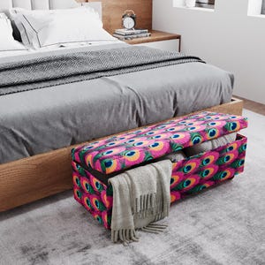 a bedroom with a bed, a wooden headboard, and a colorful storage box with a patterned design on the floor.
