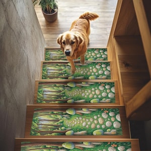 May include: A golden retriever dog walks down a wooden staircase with decorative stair treads. The treads feature a forest scene with trees, rocks, and green grass. A potted plant sits at the top of the stairs.