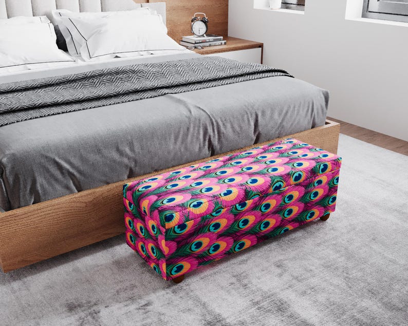 a bedroom with a bed, a wooden headboard, and a colorful patterned ottoman placed on the floor.