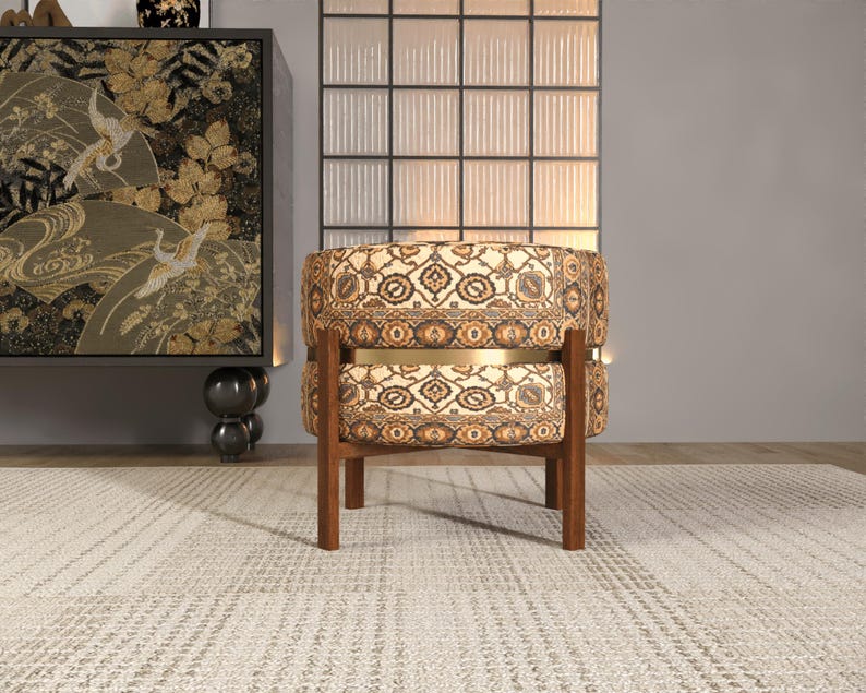 a modern, circular chair with a floral patterned upholstery, placed on a white rug in a minimalist setting.