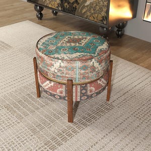 a decorative ottoman with a colorful, patterned design sitting on a beige rug in a room.