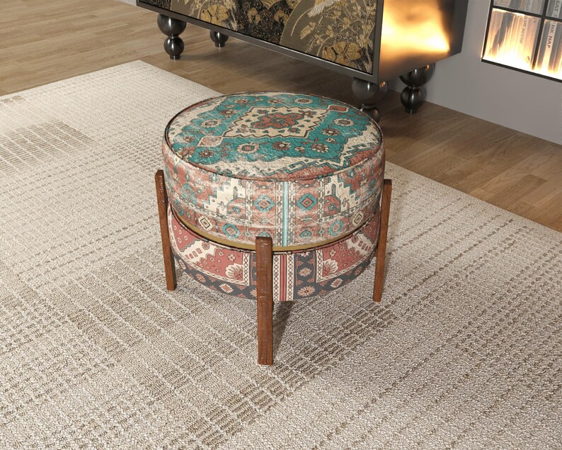 a decorative ottoman with a colorful, patterned design sitting on a beige rug in a room.