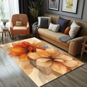 Könnte beinhalten: Ein floral gemusterter Teppich mit beigefarbenem Hintergrund und zwei großen orangefarbenen und braunen Blumen. Die Blumen haben einen Aquarell-Effekt und sind übereinander gelegt.