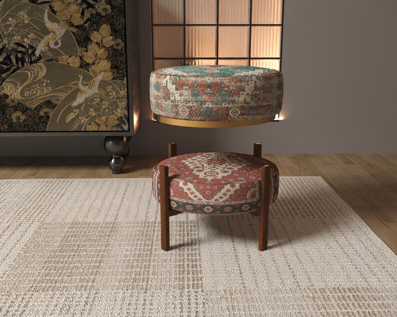 a modern living room with a rug, a wooden ottoman, and a large wall art piece.