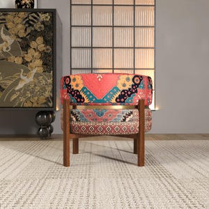 a vibrant, patterned chair with a wooden frame, placed on a white rug in a minimalist setting.