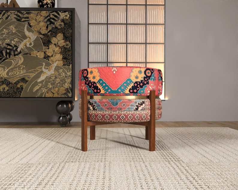 a vibrant, patterned chair with a wooden frame, placed on a white rug in a minimalist setting.