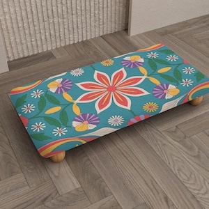 May include: A white ceramic mug with a black handle and the text "But First, Coffee" in a handwritten style. The mug is on a white surface. The mug is approximately 4 inches tall.