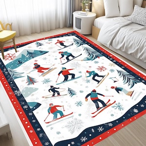 May include: A white area rug with a red and blue border features a winter sports theme. The rug depicts skiers in various poses on a snowy mountain landscape with blue pine trees and snowflakes.