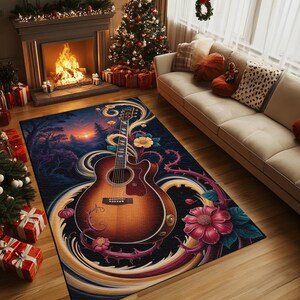 Op de afbeelding: Een rechthoekig vloerkleed met een ontwerp van een akoestische gitaar en bloemaccenten. Het kleed heeft een donkerblauwe achtergrond met een zonsondergang. De gitaar is bruin en goudkleurig, met rode en roze bloemen.