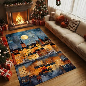 May include: A rectangular rug with a watercolour depiction of a city at night, complete with a full moon and a starry sky. The rug's design showcases buildings with lit windows, mirrored in the water. The scene is set in a room with a fireplace and Christmas decorations.