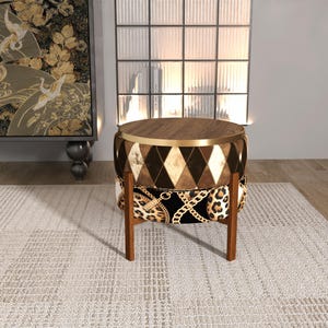 May include: A decorative round side table with a wooden top and legs. The table's body features a diamond pattern in shades of brown and gold, with a leopard print and gold chain design at the base.