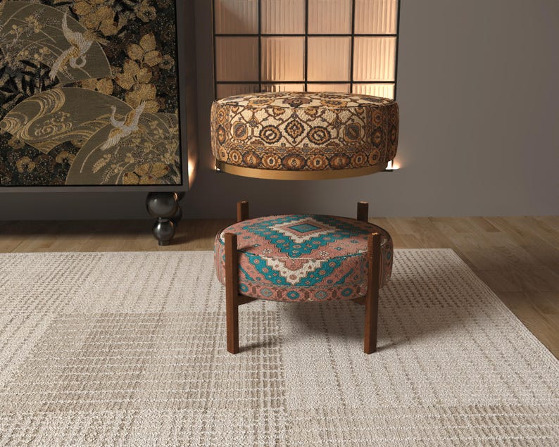 a modern living room with a rug, a colorful ottoman, and a large wall art piece.