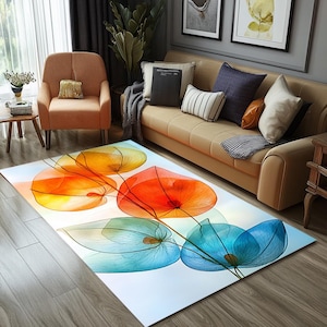 May include: Abstract floral area rug with a white background and overlapping translucent flowers in shades of orange, red, and blue.