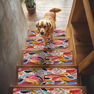 May include: A set of four colorful stair treads with a floral pattern. The treads are made of a durable material and are designed to help prevent slips and falls. The treads are shown on a wooden staircase with a dog standing on the top tread.