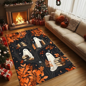 May include: A black and orange Halloween-themed rug with a design of three white ghosts sitting on stacks of books in a tree. The tree has orange leaves and the background is a dark blue with stars.