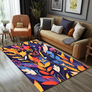 Könnte beinhalten: Ein rechteckiger Teppich mit einem farbenfrohen Blumenmuster. Der Teppich hat einen dunkelblauen Hintergrund mit bunten Blättern und Blumen in Orange, Gelb, Rosa und Blau. Er liegt auf einem Holzboden in einem Wohnzimmer.