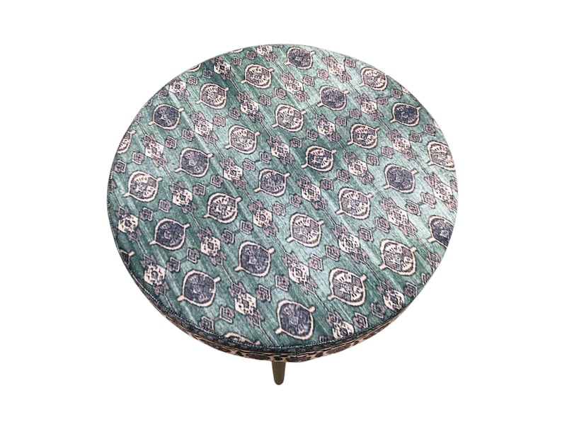 a round table with a patterned seat cover.