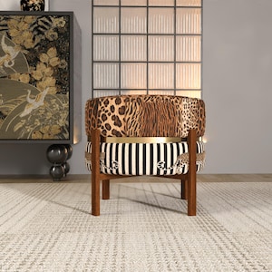 a stylish chair with a leopard print cushion and a striped seat, placed in a room with a large window and a decorative wall.