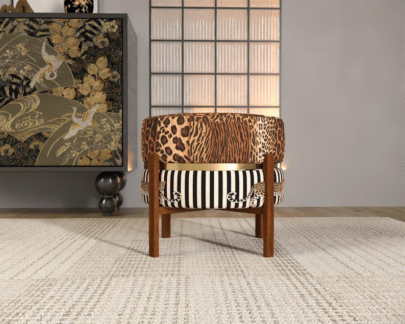 a stylish chair with a leopard print cushion and a striped seat, placed in a room with a large window and a decorative wall.