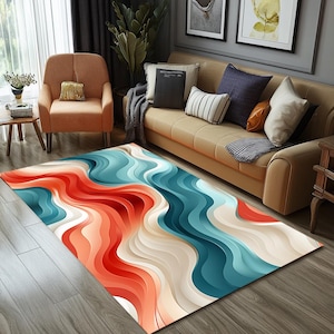 May include: Abstract area rug with a wavy pattern in shades of red, blue, and white. The rug is laid out on a wooden floor in a living room setting.