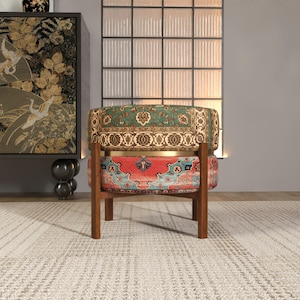 a colorful, patterned chair with a wooden frame, placed in a room with a large window and a decorative cabinet.