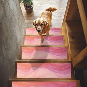 May include: A golden retriever dog stands on a set of stairs with pink and orange abstract patterned stair treads.