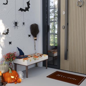 May include: A Halloween-themed entrance with a bench, pumpkins, and decorations. The bench has a patterned cushion, and a witch hat sits on top. Bats and spiders hang on the wall. A welcome mat is on the floor.