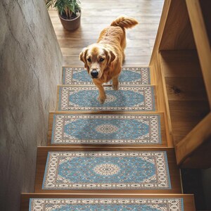 May include: Wooden staircase with blue and beige patterned stair treads. A golden retriever dog is walking down the stairs. A potted plant is visible at the top of the stairs.