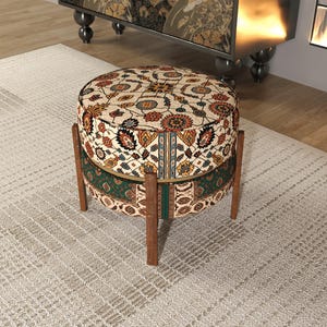 a decorative ottoman with a colorful, patterned design sitting on a rug in a room.