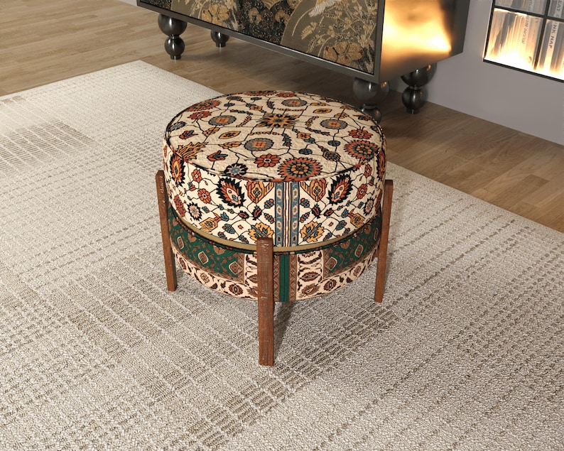 a decorative ottoman with a colorful, patterned design sitting on a rug in a room.