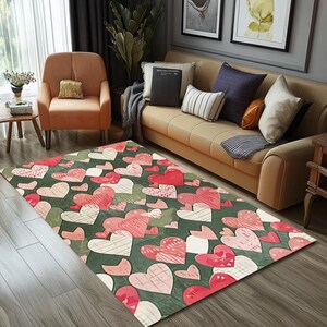May include: A green and pink area rug with a repeating pattern of hearts. The hearts are in various shades of pink and white with a green background.