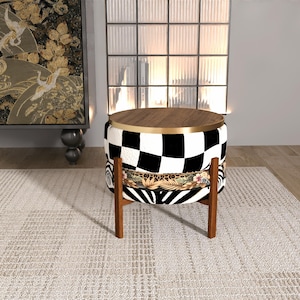 May include: A round ottoman with a wooden top and legs. The body features a black and white checkerboard pattern, a floral and animal print band, and a zebra print base. The ottoman is a decorative furniture piece.